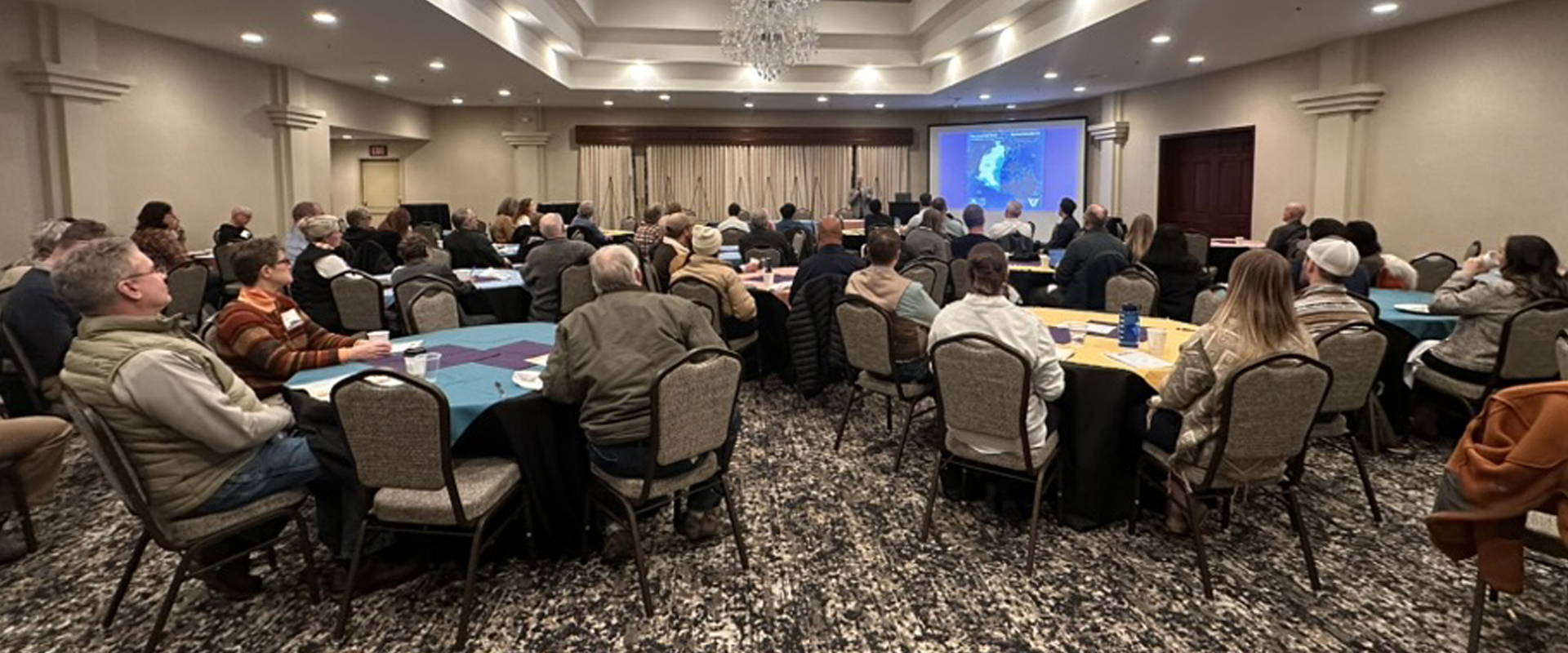 Attendees engage in a professional conference setting, fostering networking and collaborative learning.