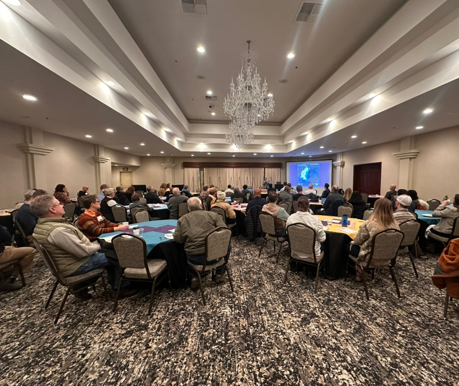 Diverse attendees engage in a vibrant conference setting, fostering networking and knowledge sharing.