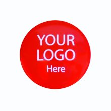 Customizable red promotional button for logo display and brand awareness.