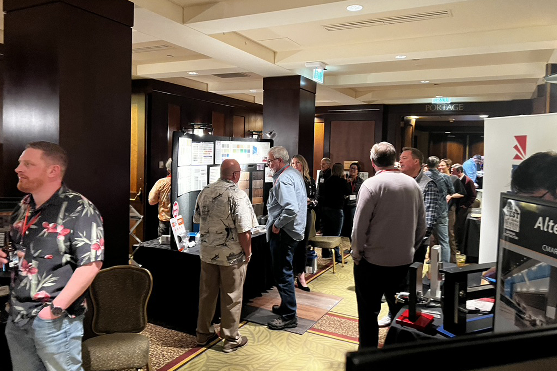 Busy networking event in a conference center featuring diverse attendees and vibrant booths.